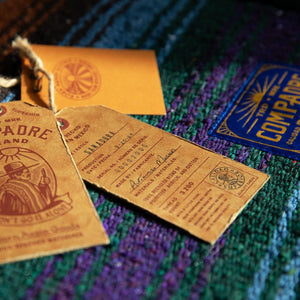 Woven Mexican Blanket Hang Tags on Blue and Green Blanket