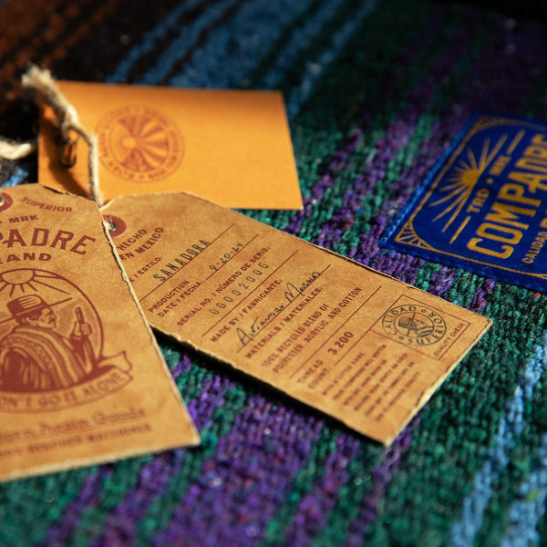 Woven Mexican Blanket Hang Tags on Blue and Green Blanket